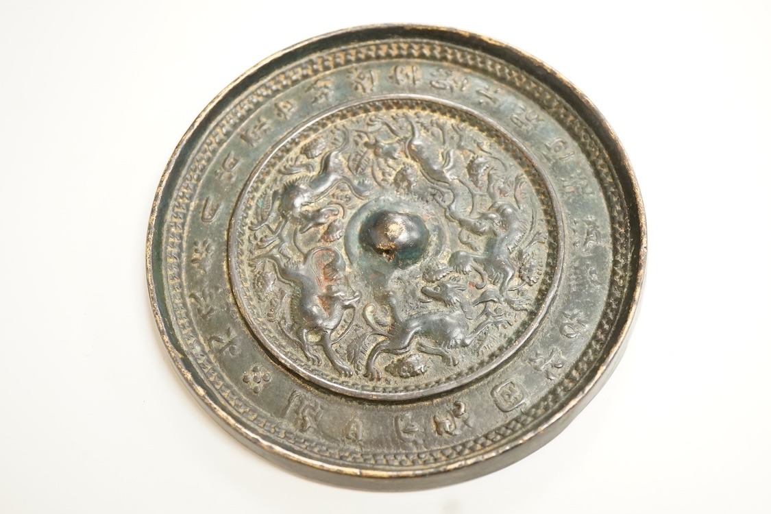 Two Chinese metal hand-mirrors, largest 13cm